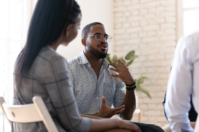 man talks addiction in therapy