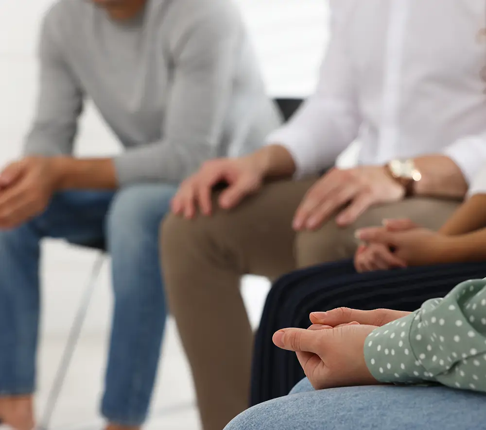 People gathered in a circle for a group therapy session